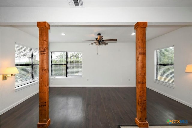 interior space with dark wood-type flooring, ceiling fan, and decorative columns