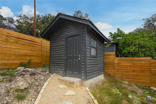 view of shed with a fenced backyard