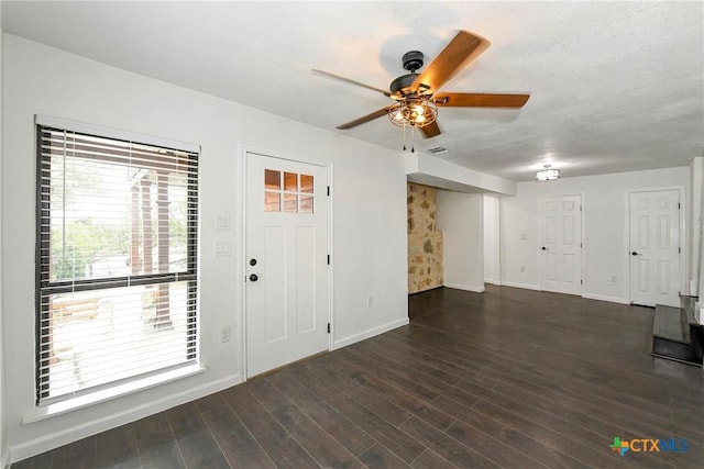 entryway featuring visible vents, baseboards, wood finished floors, and a ceiling fan