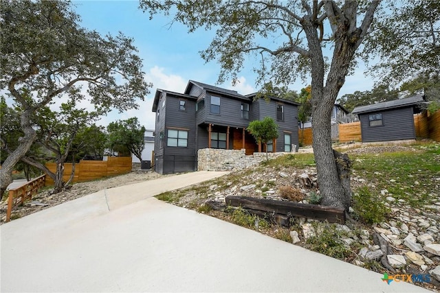 view of front of property with a storage shed