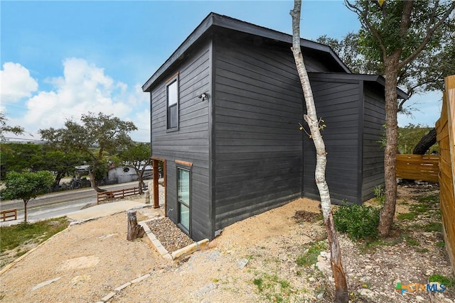 view of home's exterior featuring fence