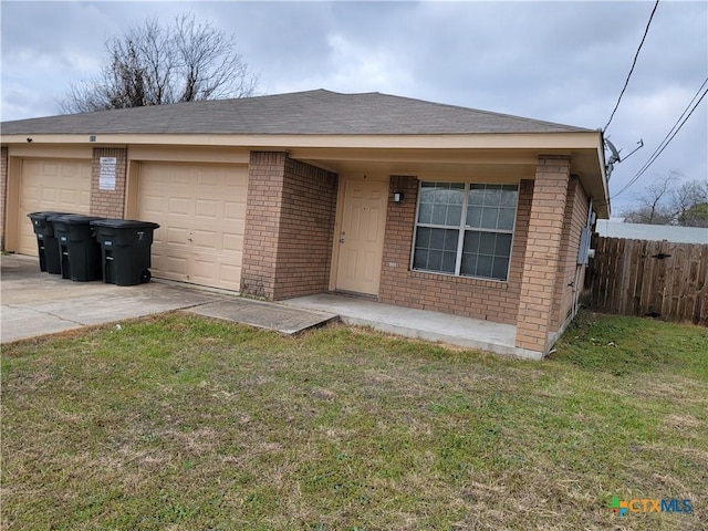 ranch-style home with concrete driveway, brick siding, and fence