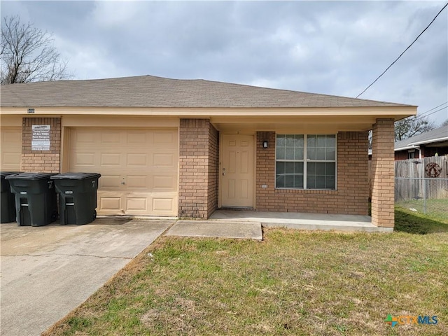 ranch-style home featuring a garage, brick siding, fence, concrete driveway, and a front yard