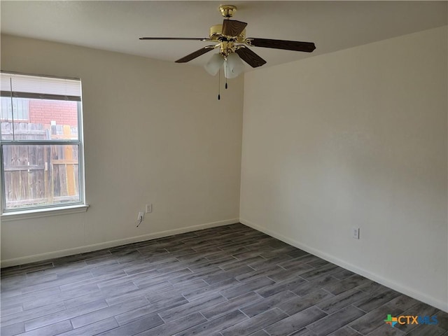 unfurnished room featuring dark wood-style floors, baseboards, and a ceiling fan