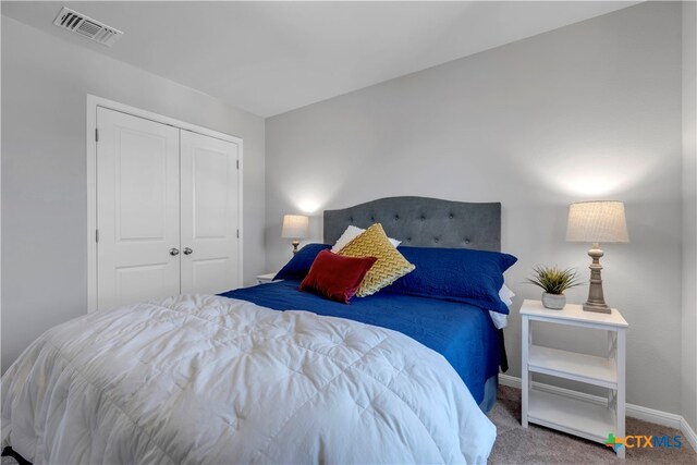 carpeted bedroom featuring a closet