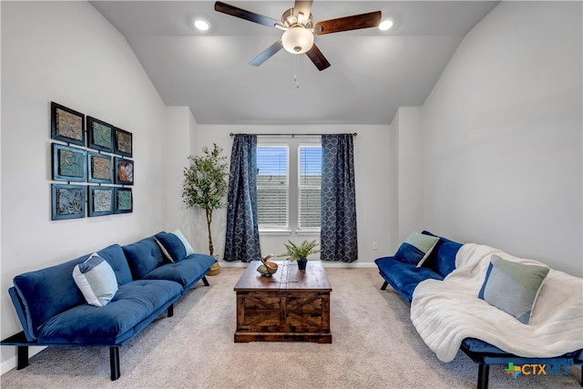 carpeted living room featuring ceiling fan and vaulted ceiling