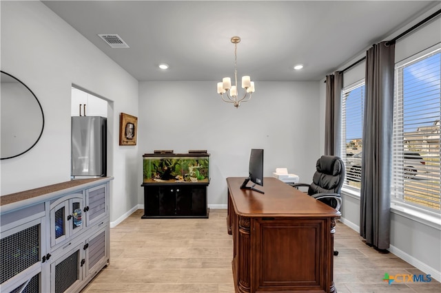 office featuring an inviting chandelier and light hardwood / wood-style flooring