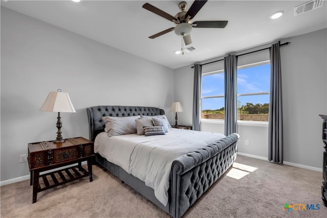 bedroom with light carpet and ceiling fan