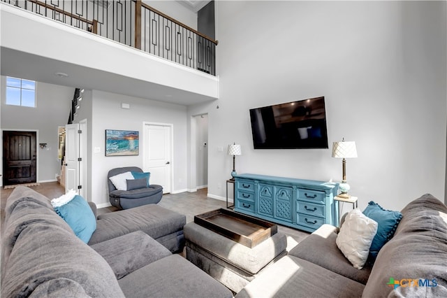 living room featuring wood-type flooring and a high ceiling