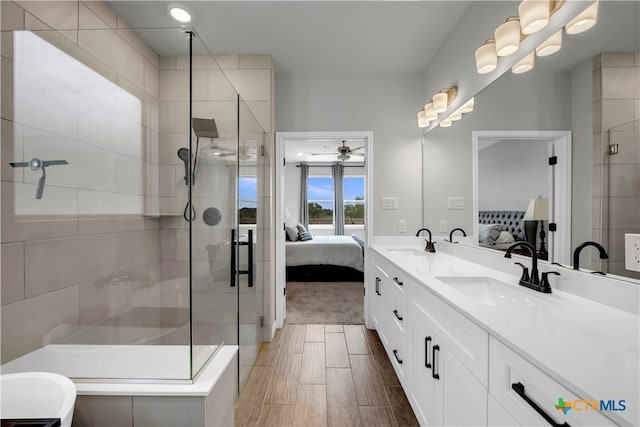 bathroom featuring ceiling fan, vanity, and an enclosed shower