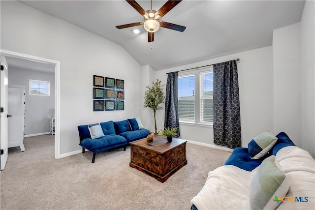 living room featuring light carpet, ceiling fan, and vaulted ceiling