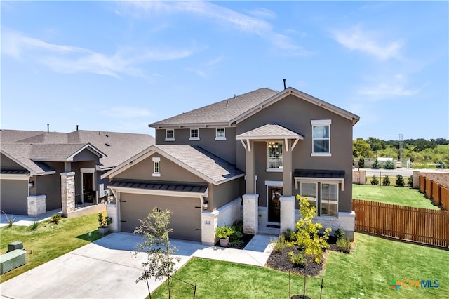 view of front of house with a front yard and a garage