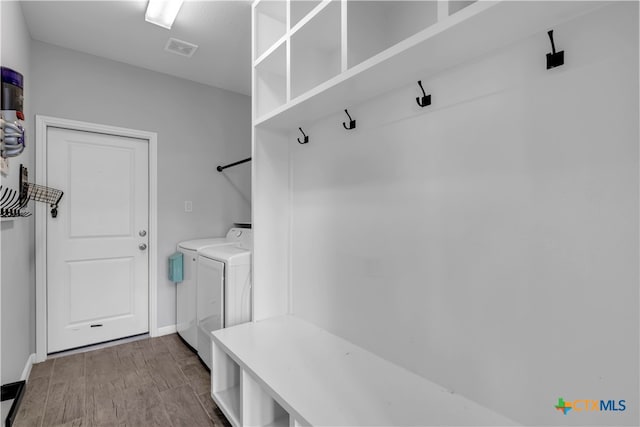 mudroom featuring hardwood / wood-style floors and separate washer and dryer