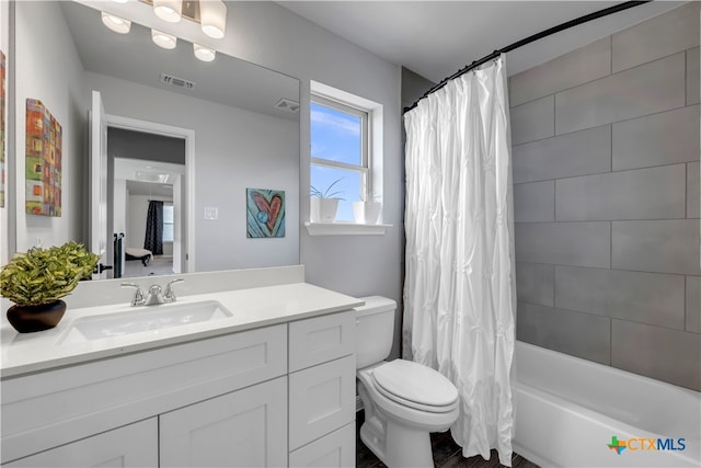 full bathroom with toilet, vanity, and shower / bath combination with curtain