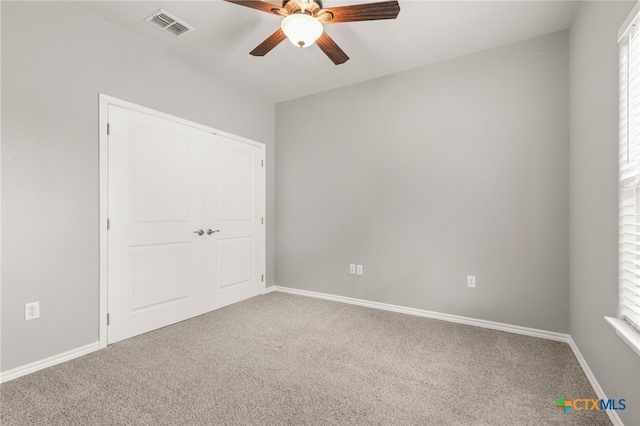 152 Navarro Xing Unit 3B, Seguin, TX 78155 - unfurnished bedroom featuring carpet, ceiling fan, and a closet