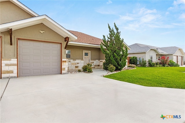 152 Navarro Xing Unit 3B, Seguin, TX 78155 - view of front facade featuring concrete driveway, stone siding, a front yard, a garage, and stucco siding