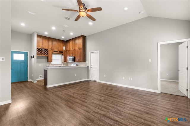 152 Navarro Xing Unit 3B, Seguin, TX 78155 - unfurnished living room with ceiling fan, dark wood-type flooring, recessed lighting, and lofted ceiling