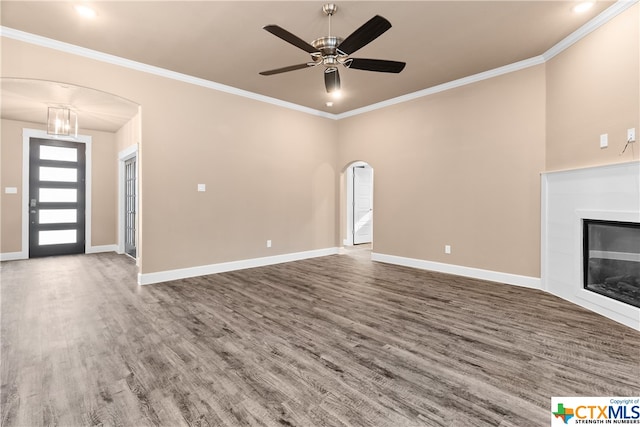 unfurnished living room with hardwood / wood-style flooring, ceiling fan, and crown molding