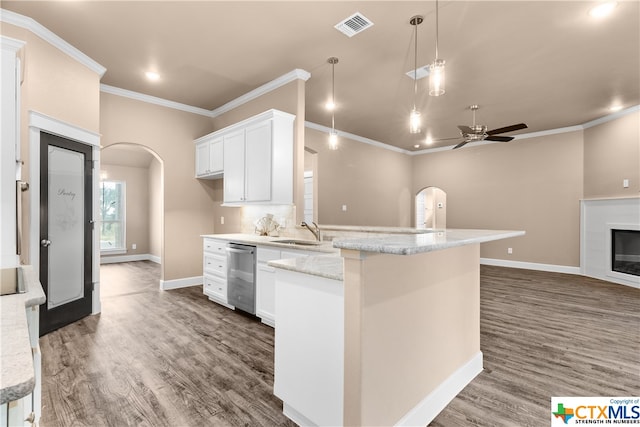 kitchen featuring dark hardwood / wood-style flooring, white cabinetry, dishwasher, and hanging light fixtures