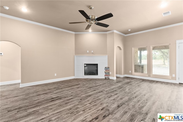 unfurnished living room featuring hardwood / wood-style floors, ceiling fan, and crown molding