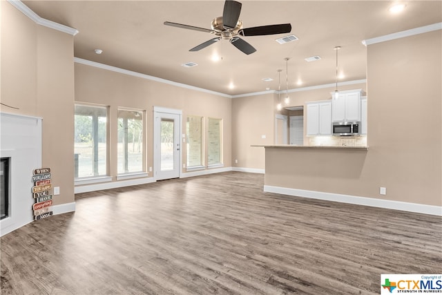 unfurnished living room featuring crown molding, ceiling fan, and dark wood-type flooring