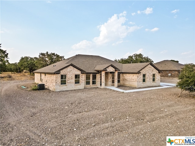 french country style house with central air condition unit