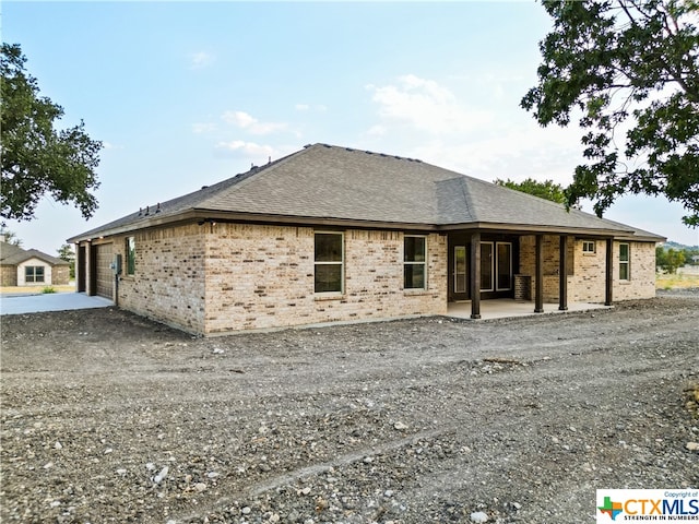 rear view of property with a garage