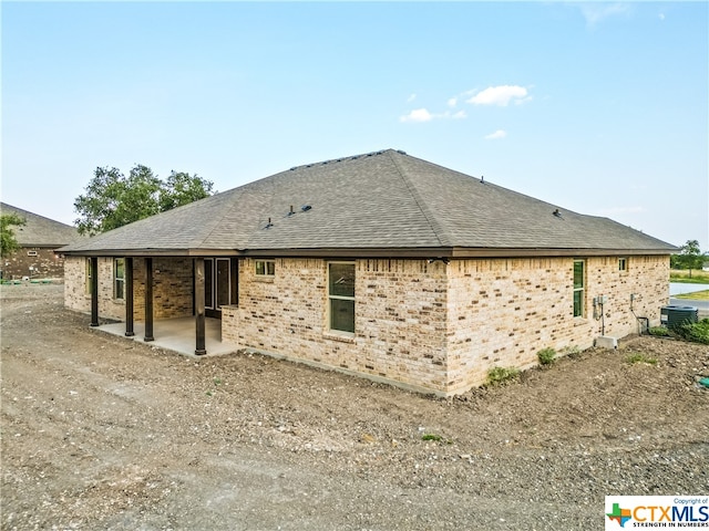 view of property exterior with a patio area and cooling unit