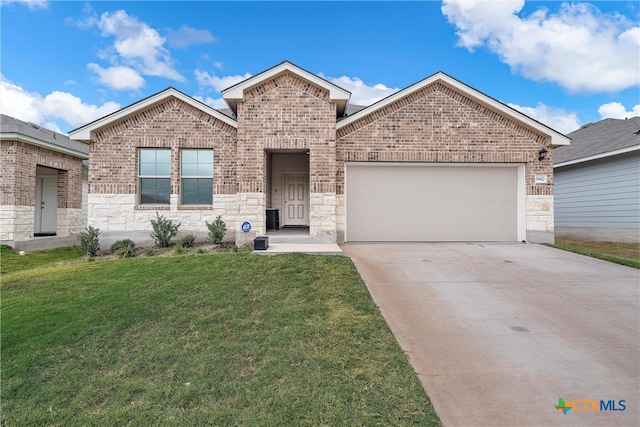 view of front of property featuring a garage and a front lawn