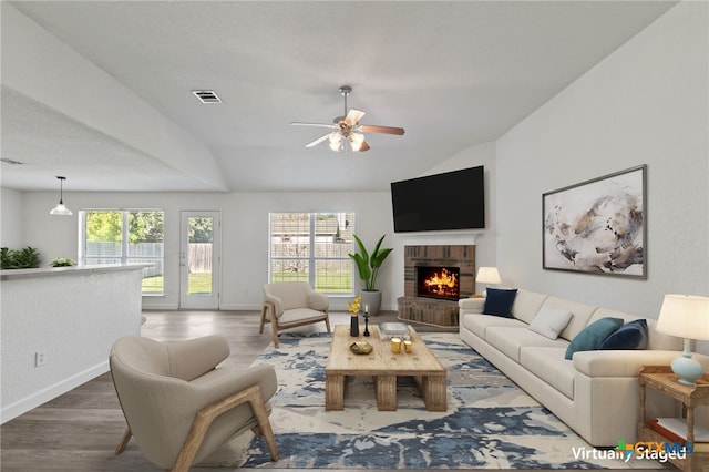 living room featuring plenty of natural light, a ceiling fan, baseboards, and visible vents
