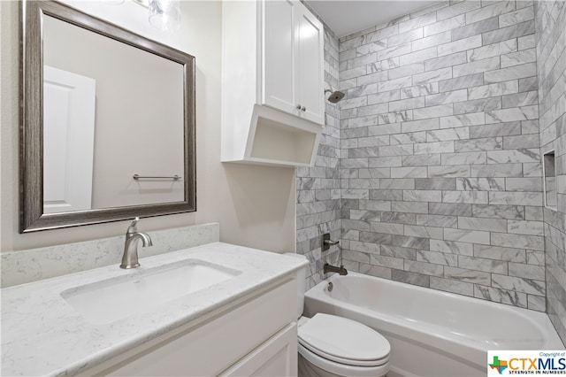 full bathroom with vanity, tiled shower / bath, and toilet