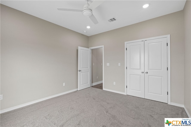 unfurnished bedroom with a closet, carpet flooring, and ceiling fan