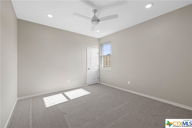 empty room with ceiling fan and carpet floors