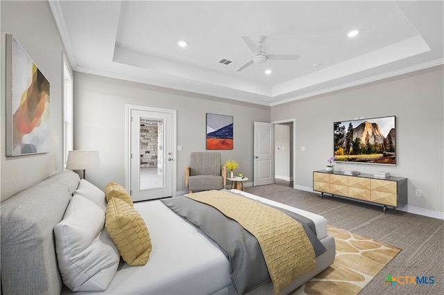 bedroom with a tray ceiling, ceiling fan, light carpet, and access to outside