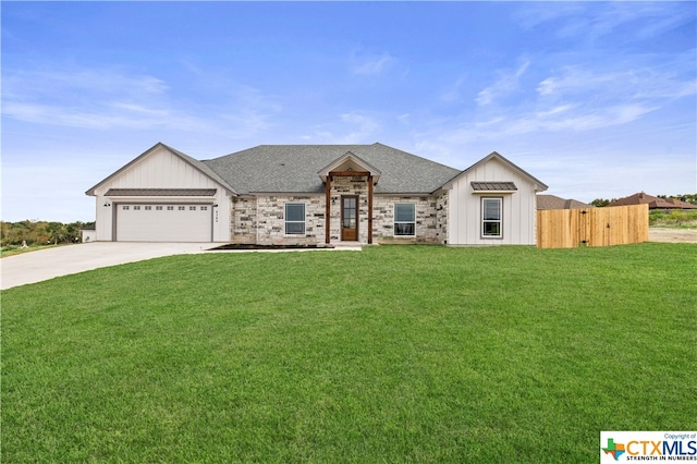 view of front of property featuring a front lawn and a garage