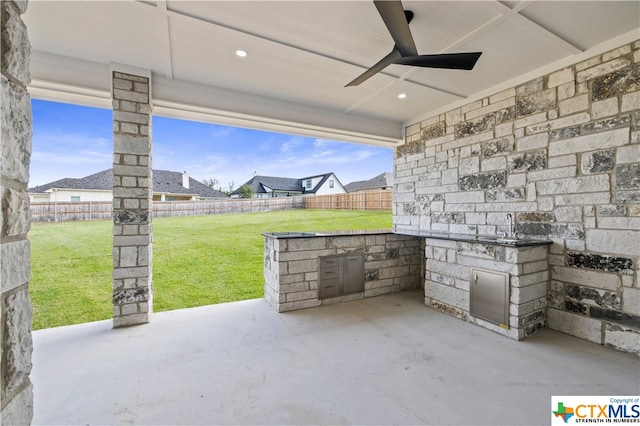 view of patio featuring ceiling fan