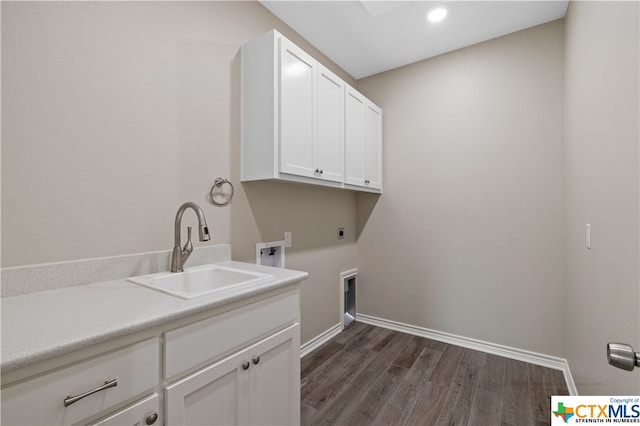 laundry area featuring cabinets, sink, electric dryer hookup, dark wood-type flooring, and hookup for a washing machine