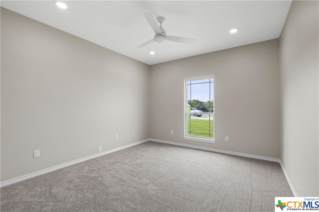 empty room featuring ceiling fan and carpet floors