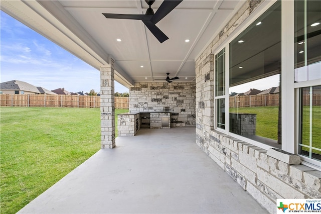 view of patio / terrace with ceiling fan and area for grilling