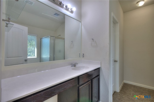 bathroom with vanity, an enclosed shower, and tile patterned flooring