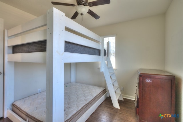 bedroom with dark wood-type flooring and ceiling fan