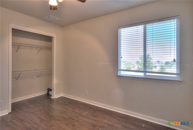 unfurnished bedroom with a closet, ceiling fan, and dark hardwood / wood-style floors