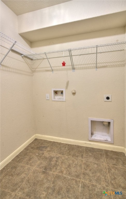 laundry room with gas dryer hookup, washer hookup, hookup for an electric dryer, and dark tile patterned floors