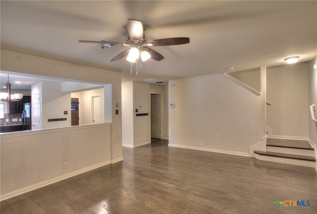 unfurnished living room featuring dark wood-type flooring and ceiling fan