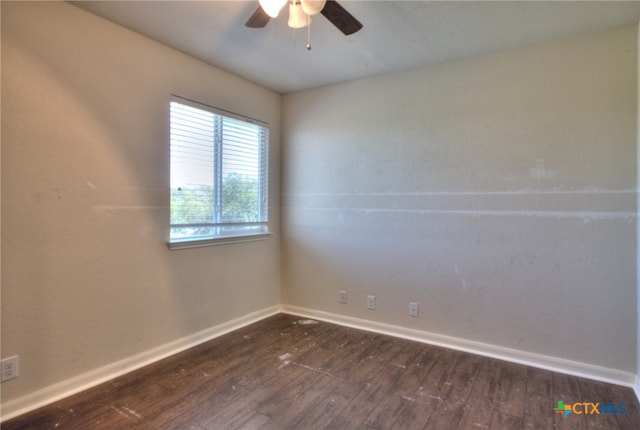 unfurnished room featuring dark wood-type flooring and ceiling fan