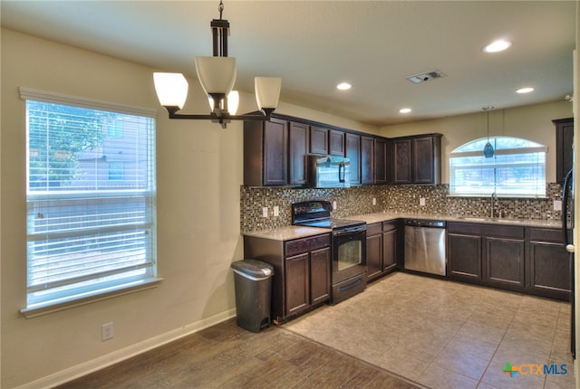 kitchen with stainless steel appliances, dark brown cabinetry, hanging light fixtures, light wood-type flooring, and decorative backsplash