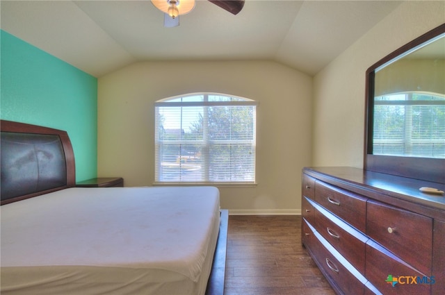 bedroom with dark wood-type flooring, multiple windows, vaulted ceiling, and ceiling fan