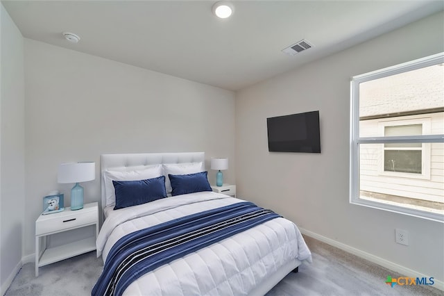bedroom with visible vents, carpet floors, and baseboards