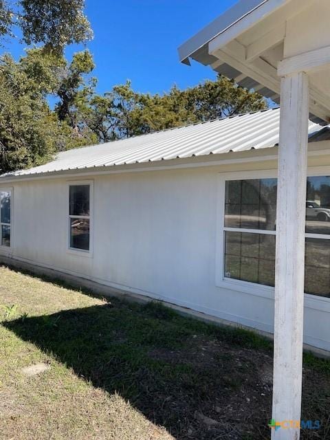 view of side of home with a yard