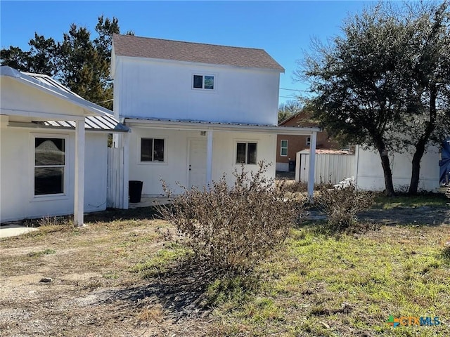 rear view of house featuring a yard